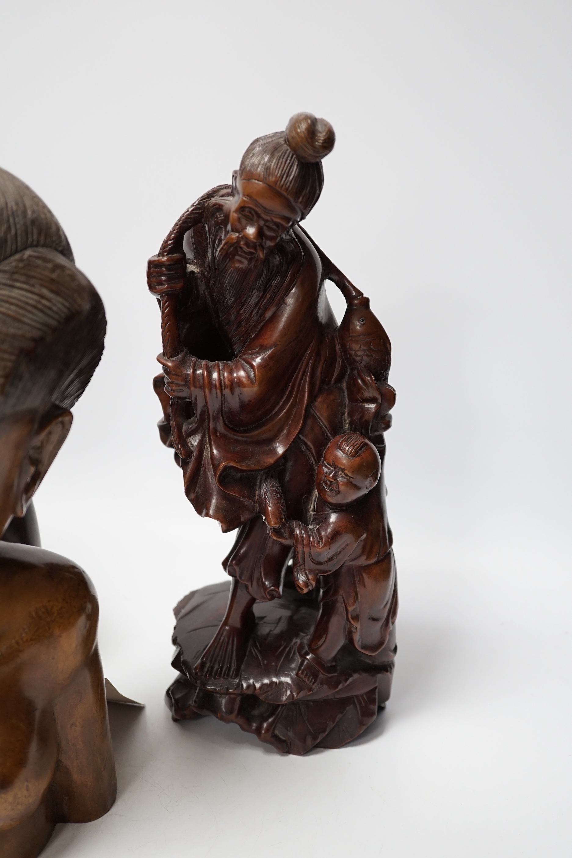 A Chinese carved rootwood figure emblematic of longevity on stand and two carved African busts, Chinese root carving 36cm high